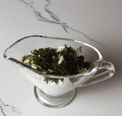 Garlic dill yogurt sauce in a small bowl, ready to accompany chicken skewers.