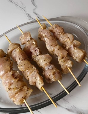 Assembled chicken skewers with marinated chicken pieces ready to be baked or grilled.