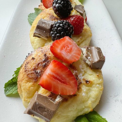 Freshly baked cottage cheese pancakes stacked on a plate