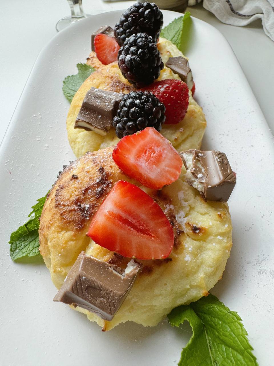 Freshly baked cottage cheese pancakes stacked on a plate