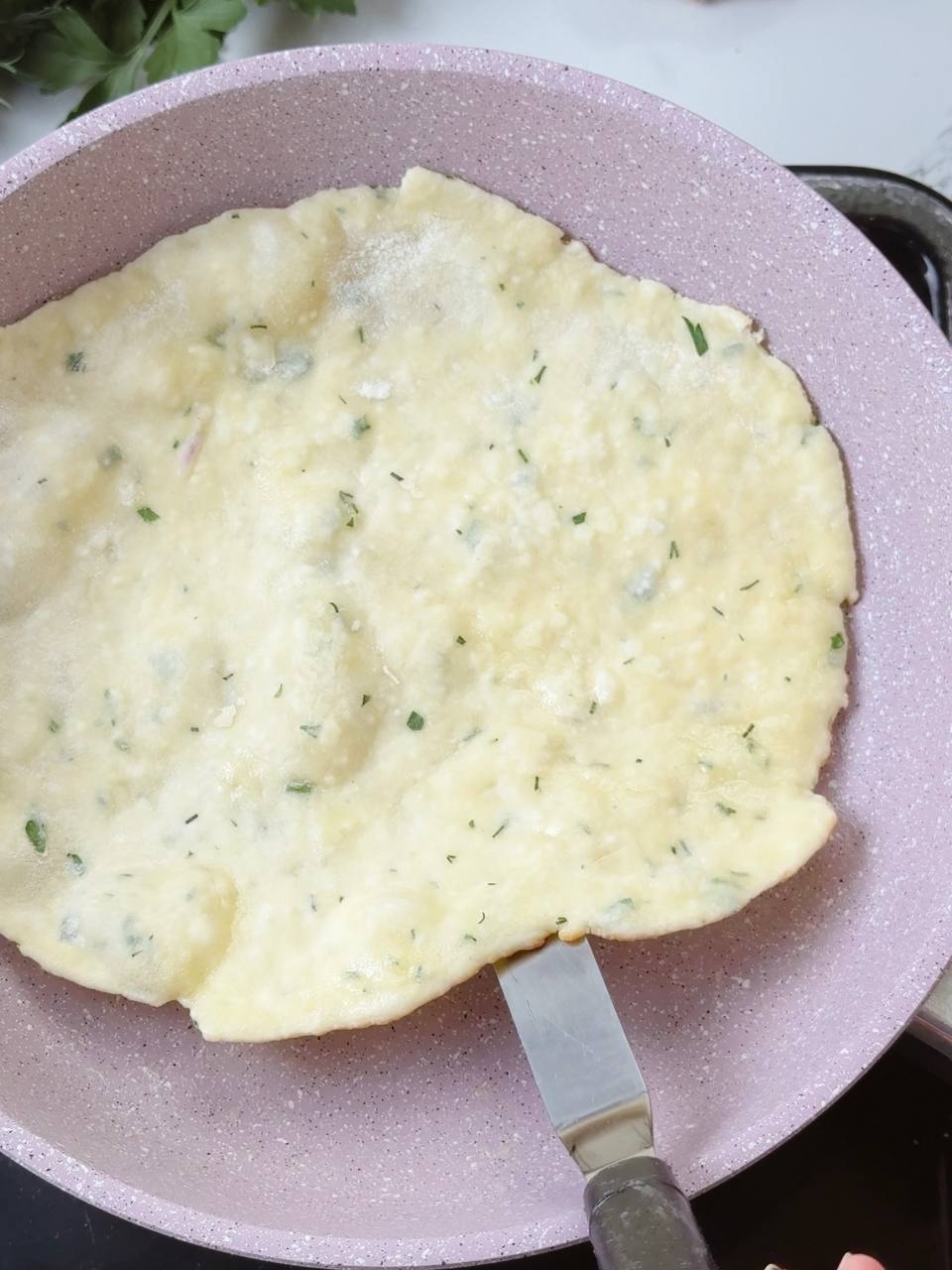 Flatbread cooking on pan before flipping