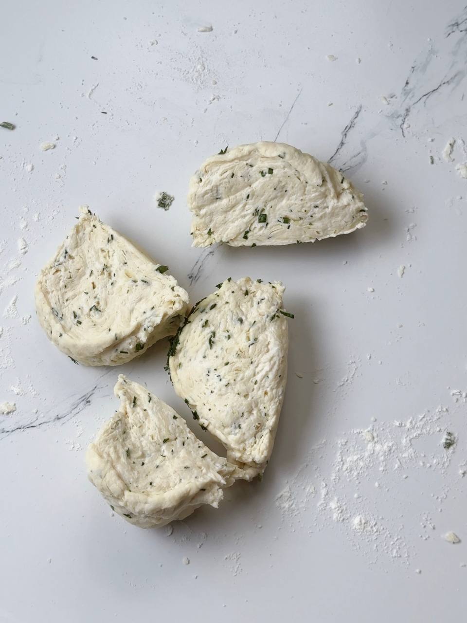 Garlic yogurt flatbread dough divided into four pieces