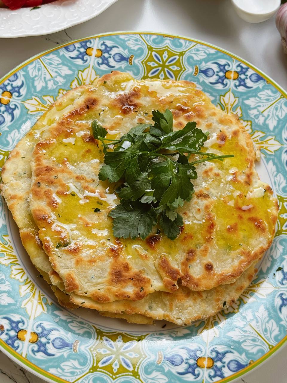 Cooked garlic yogurt flatbread on plate