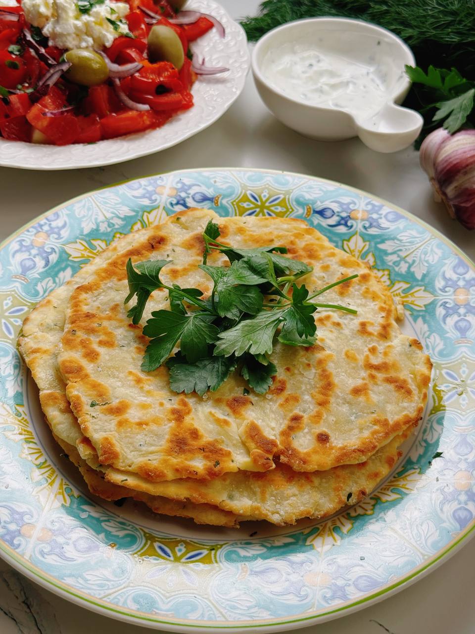 Garlic yogurt flatbread with fresh salad and garlic sauce