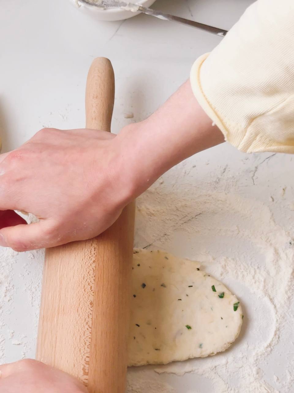 Rolling out garlic yogurt flatbread dough