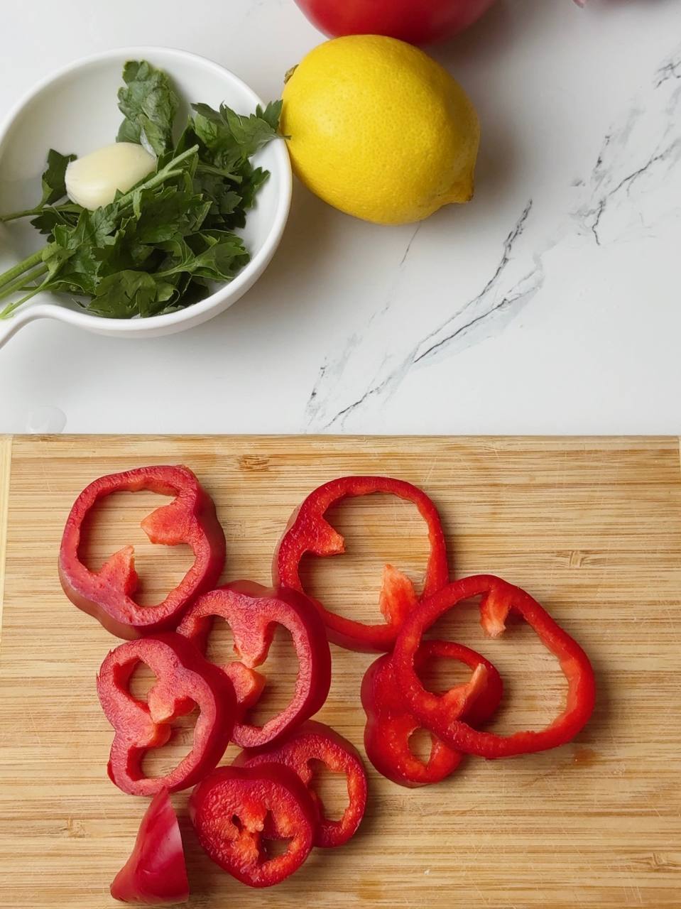 Bell pepper sliced into colorful rings for Mediterranean-style baking
