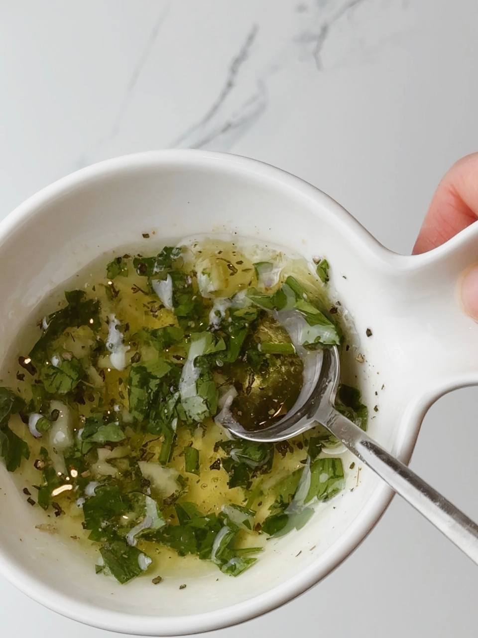 Homemade garlic lemon oil with herbs for baked fish