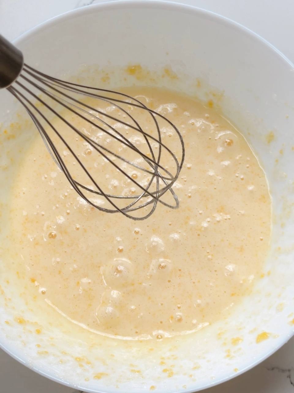 Beating eggs and sugar for lemon yogurt cake batter