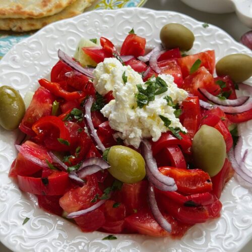 Finished Shopski Salad with vegetables, brynza, olives, and olive oil
