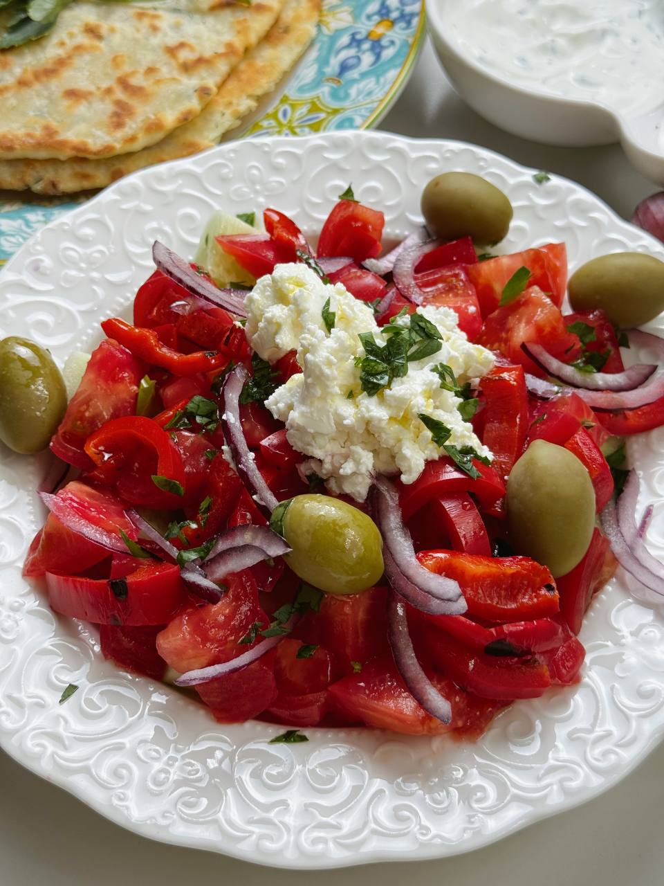 Finished Shopski Salad with vegetables, brynza, olives, and olive oil