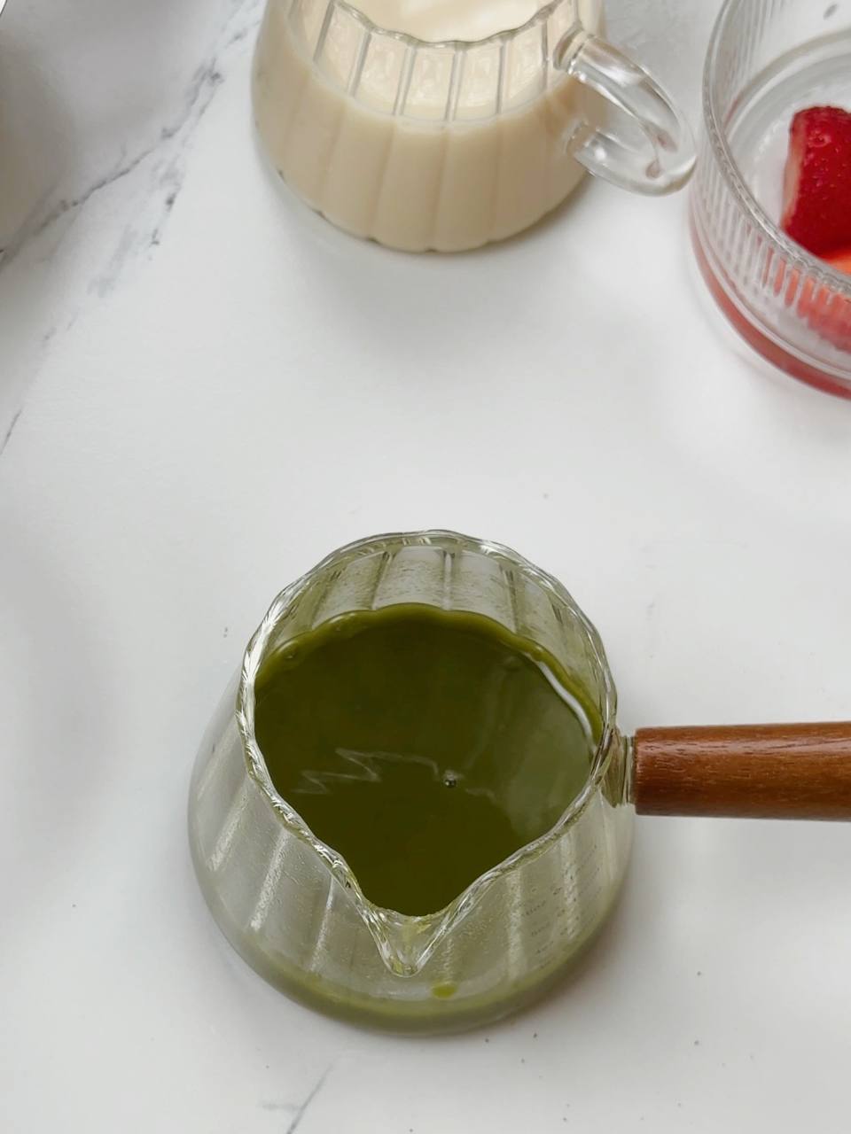 Whisked matcha with hot water in a small bowl