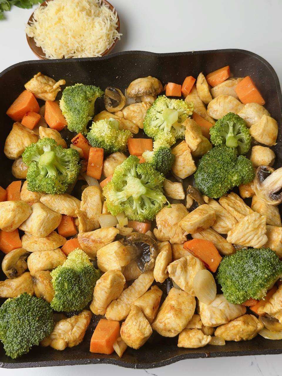 Broccoli added to pan with chicken and vegetables