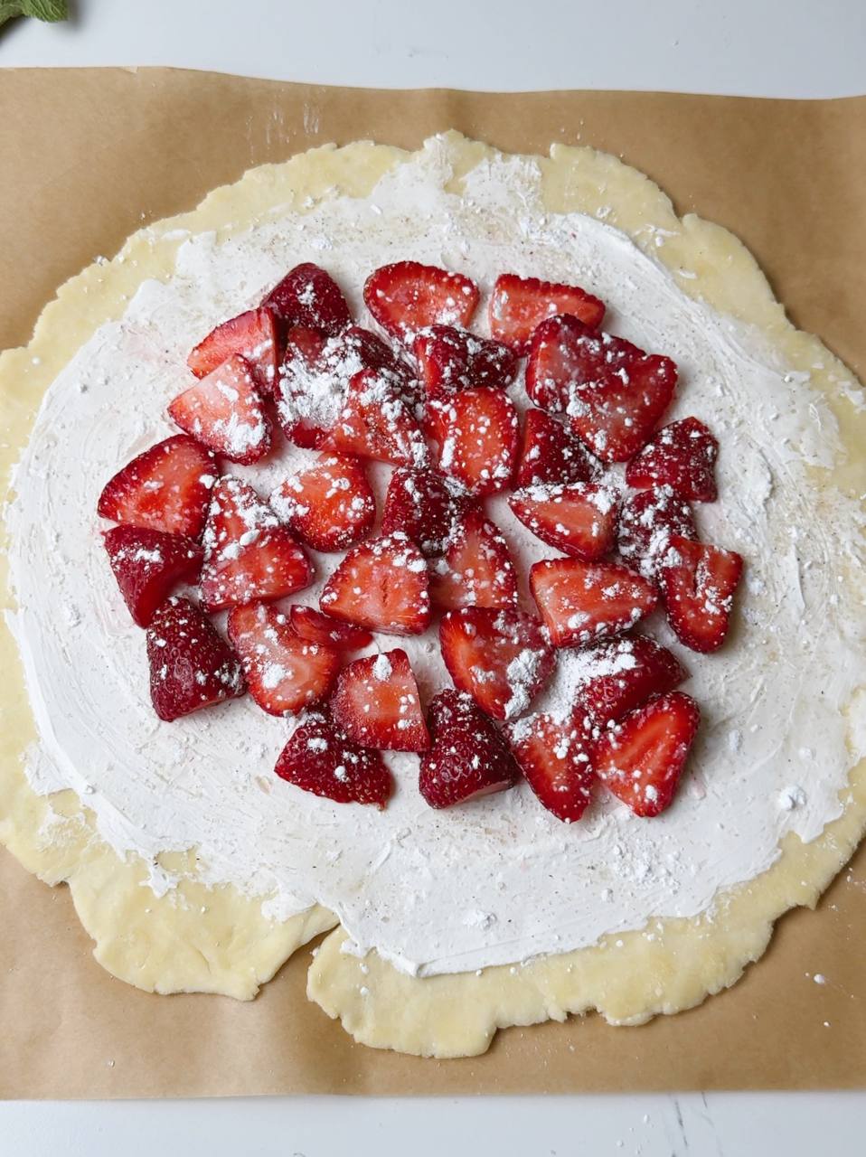 Adding halved strawberries and dusting with cornstarch
