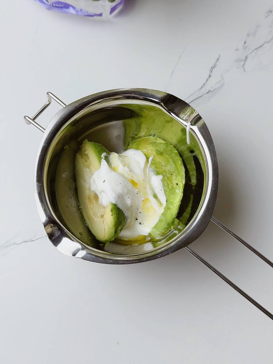 Ingredients for creamy avocado sauce before blending in a bowl