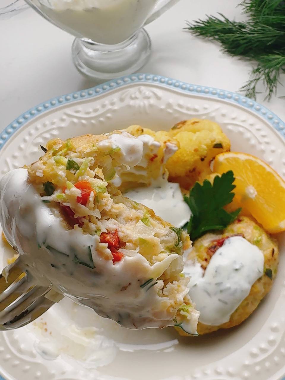 Baked chicken and zucchini fritters served with garlic sauce