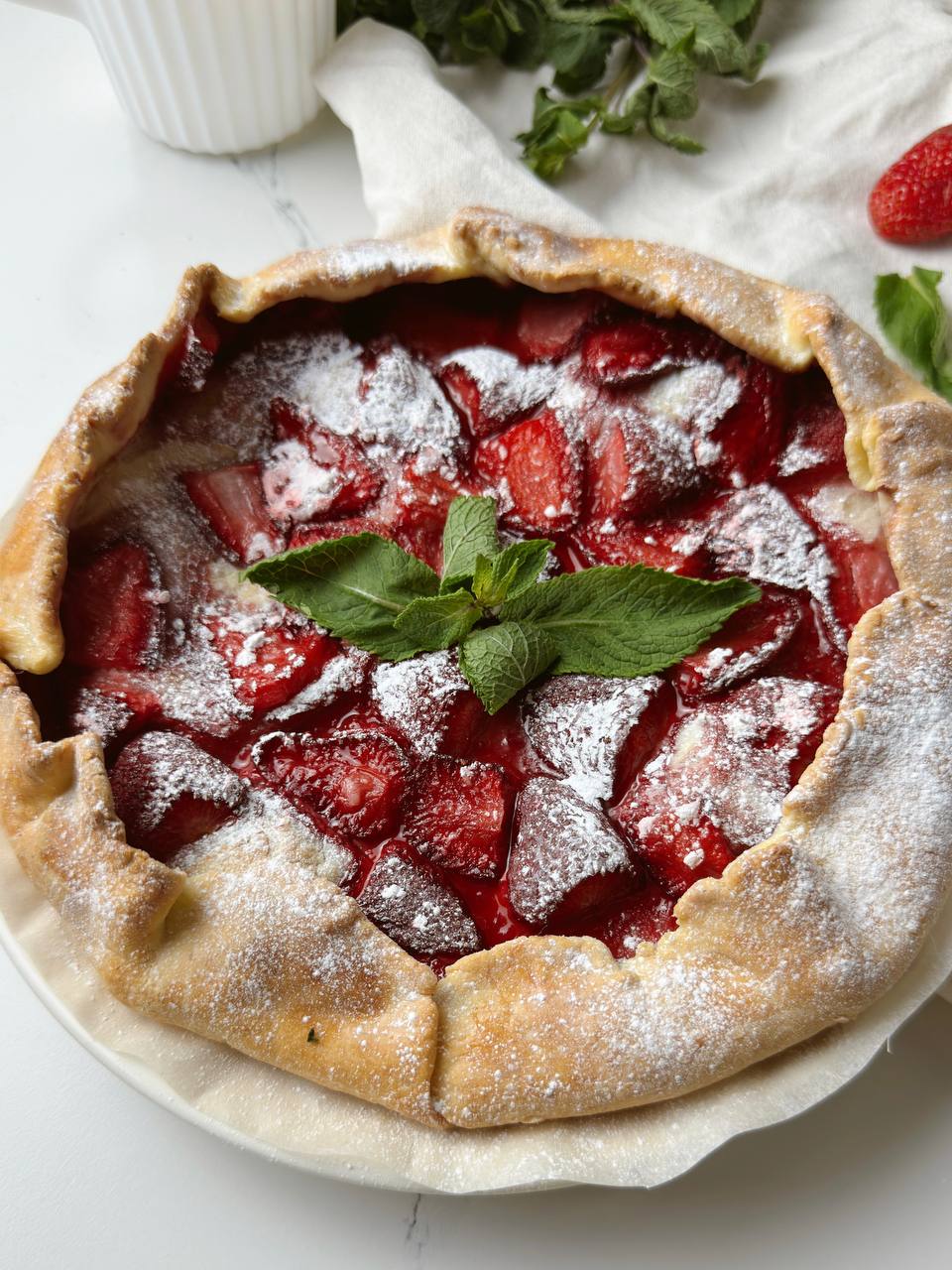 Closeup of baked strawberry galette with golden crust