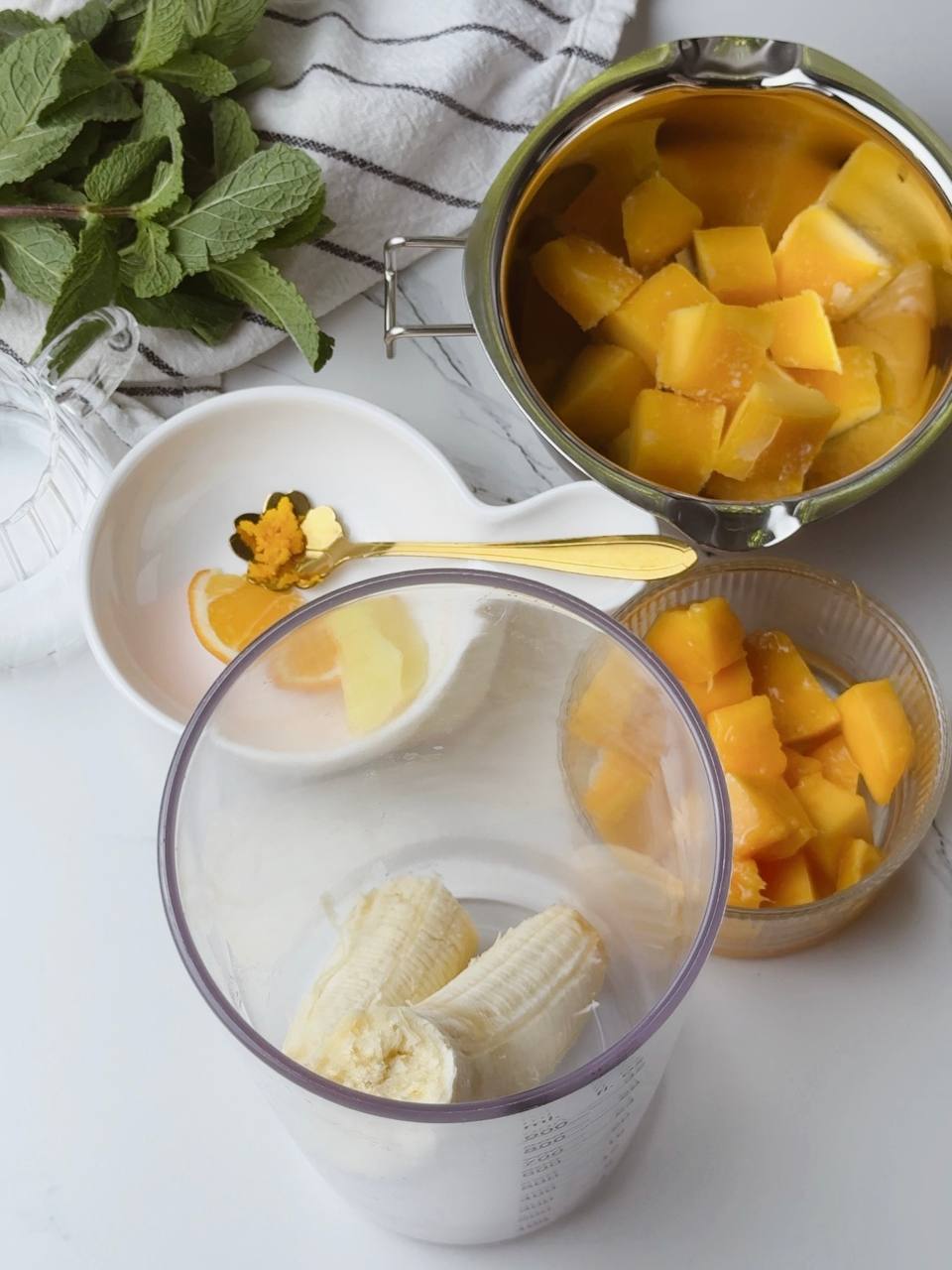 Ripe banana placed in blender cup ready for smoothie making