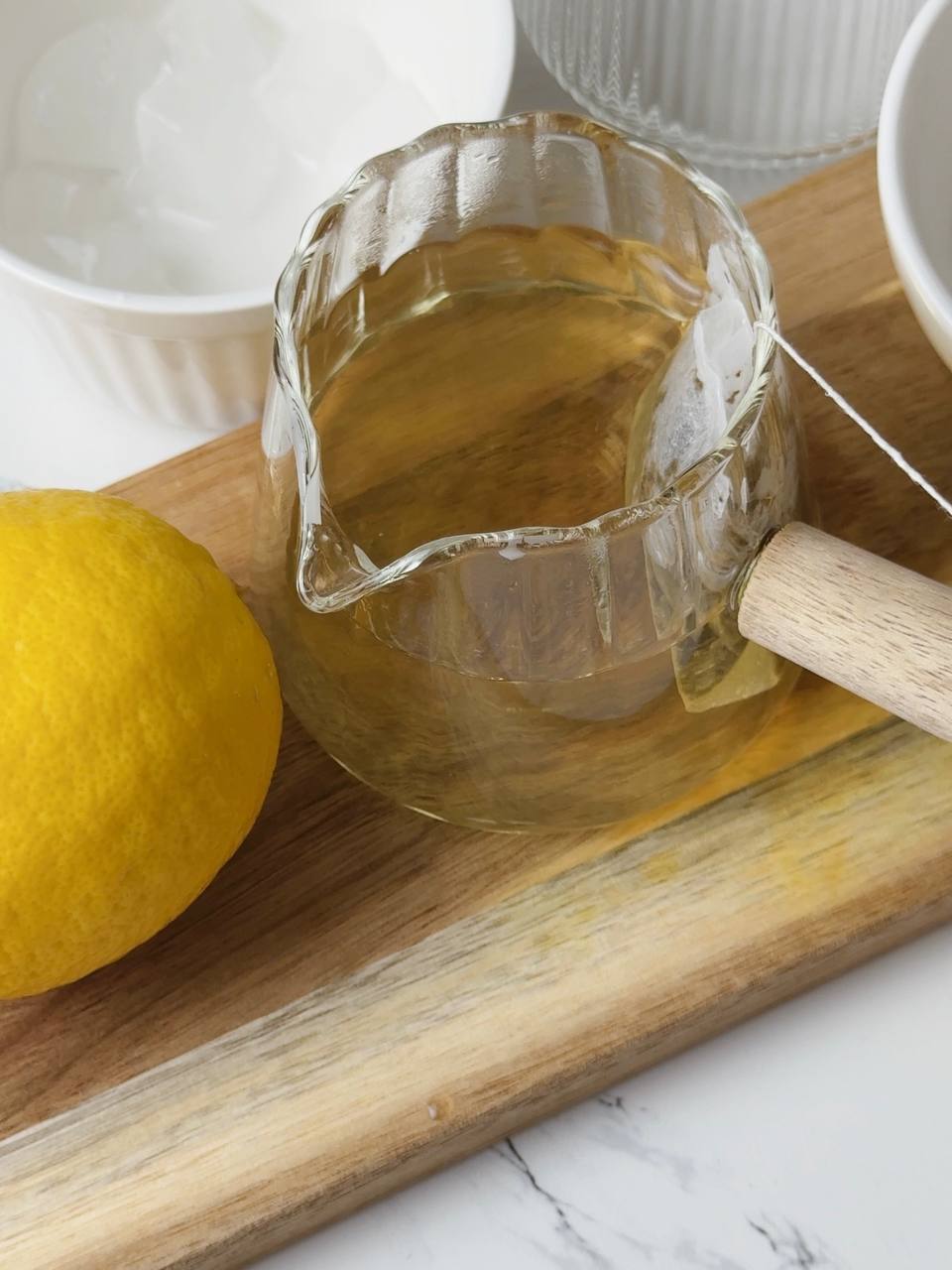 Brewing green tea in a glass pouring jug