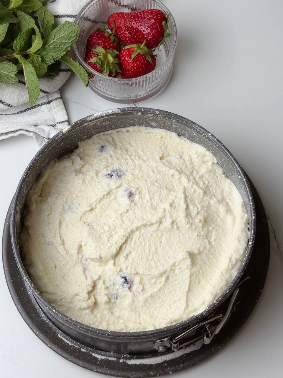Cottage cheese dessert with berries in baking dish before going into oven