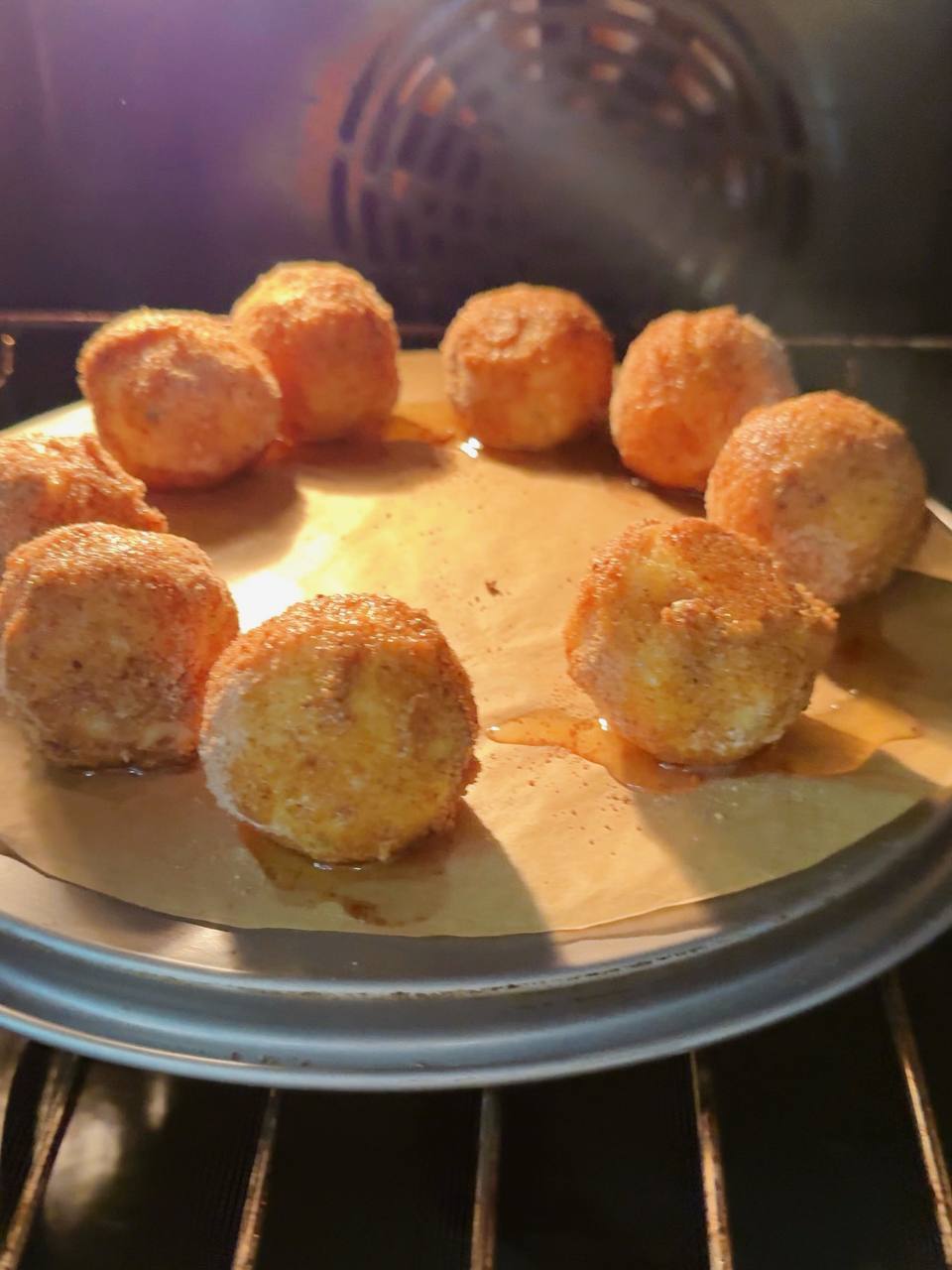 Potato croquettes baking in the oven with olive oil