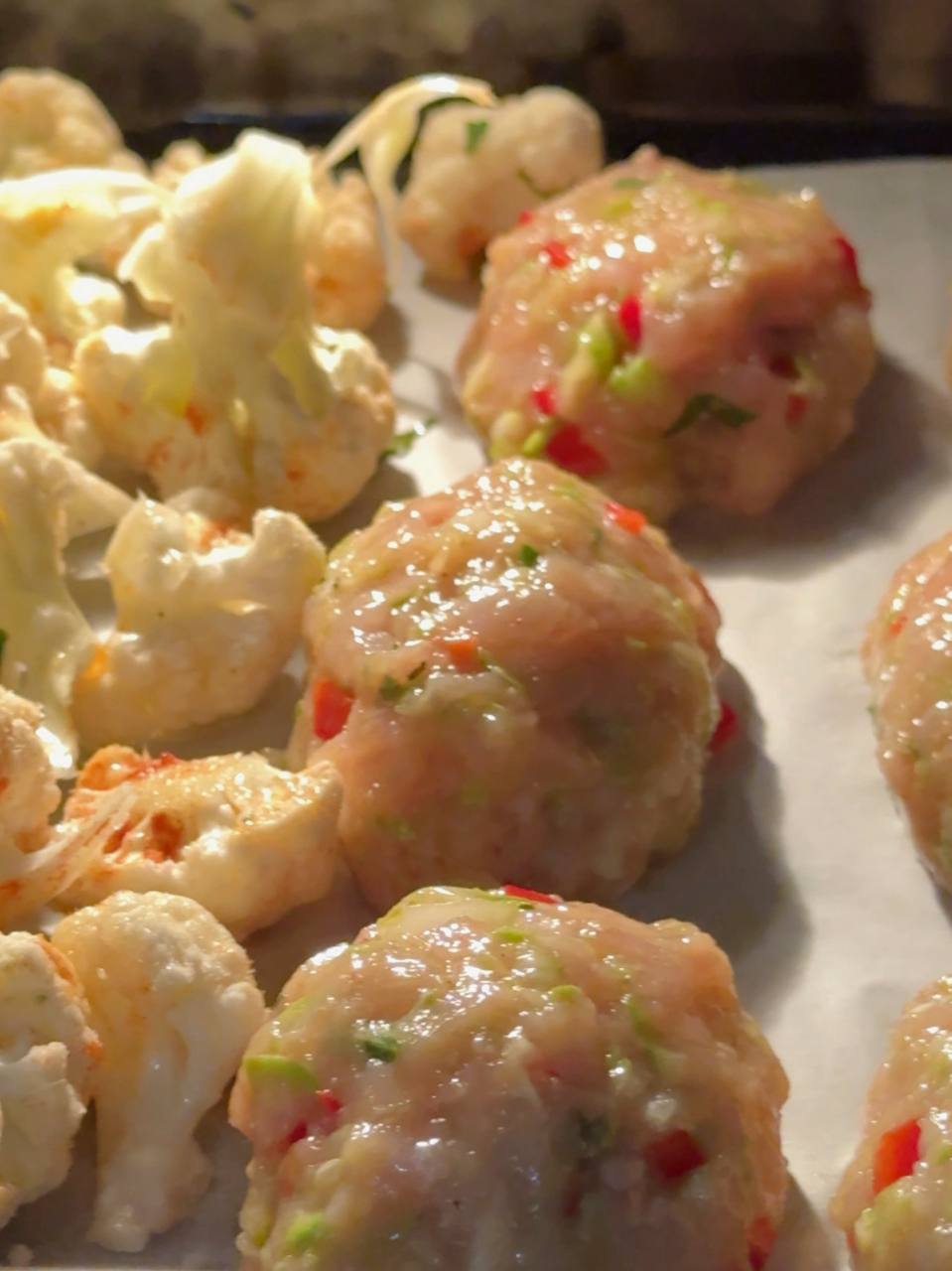Chicken fritters and cauliflower baking together in the oven