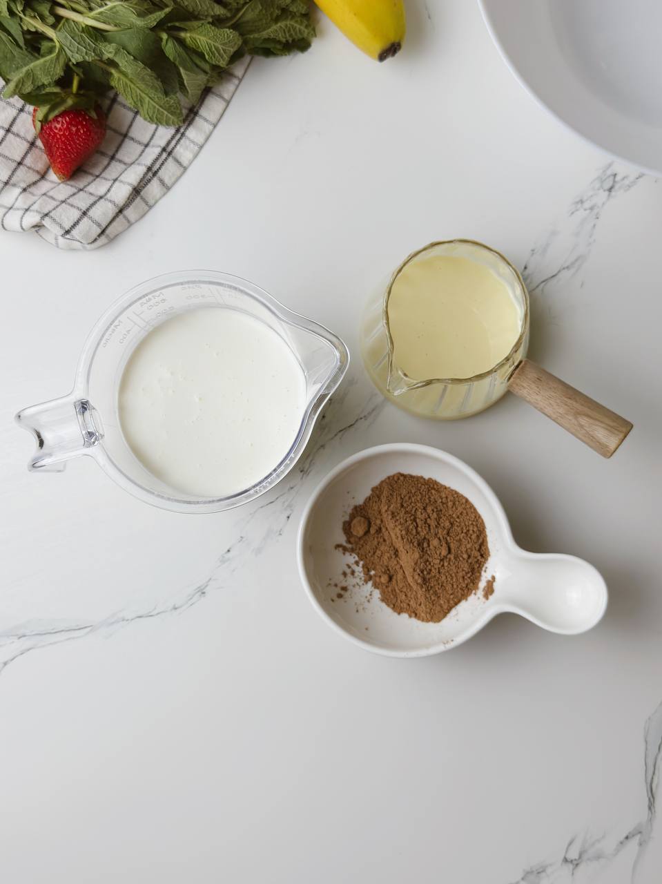 Ingredients for 3-ingredient ice cream: heavy cream, condensed milk, and cocoa powder.