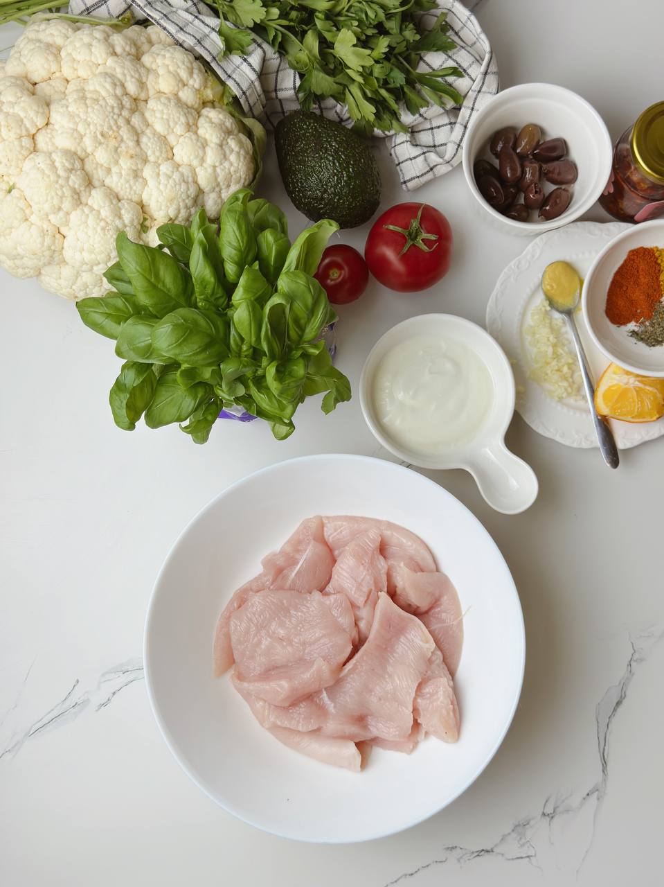 Fresh ingredients for yogurt chicken with avocado sauce and roasted cauliflower recipe