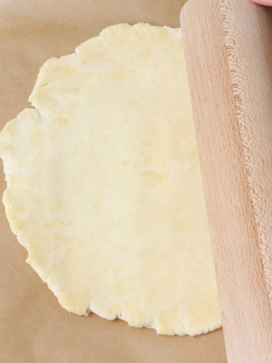 Rolling out galette dough on parchment paper