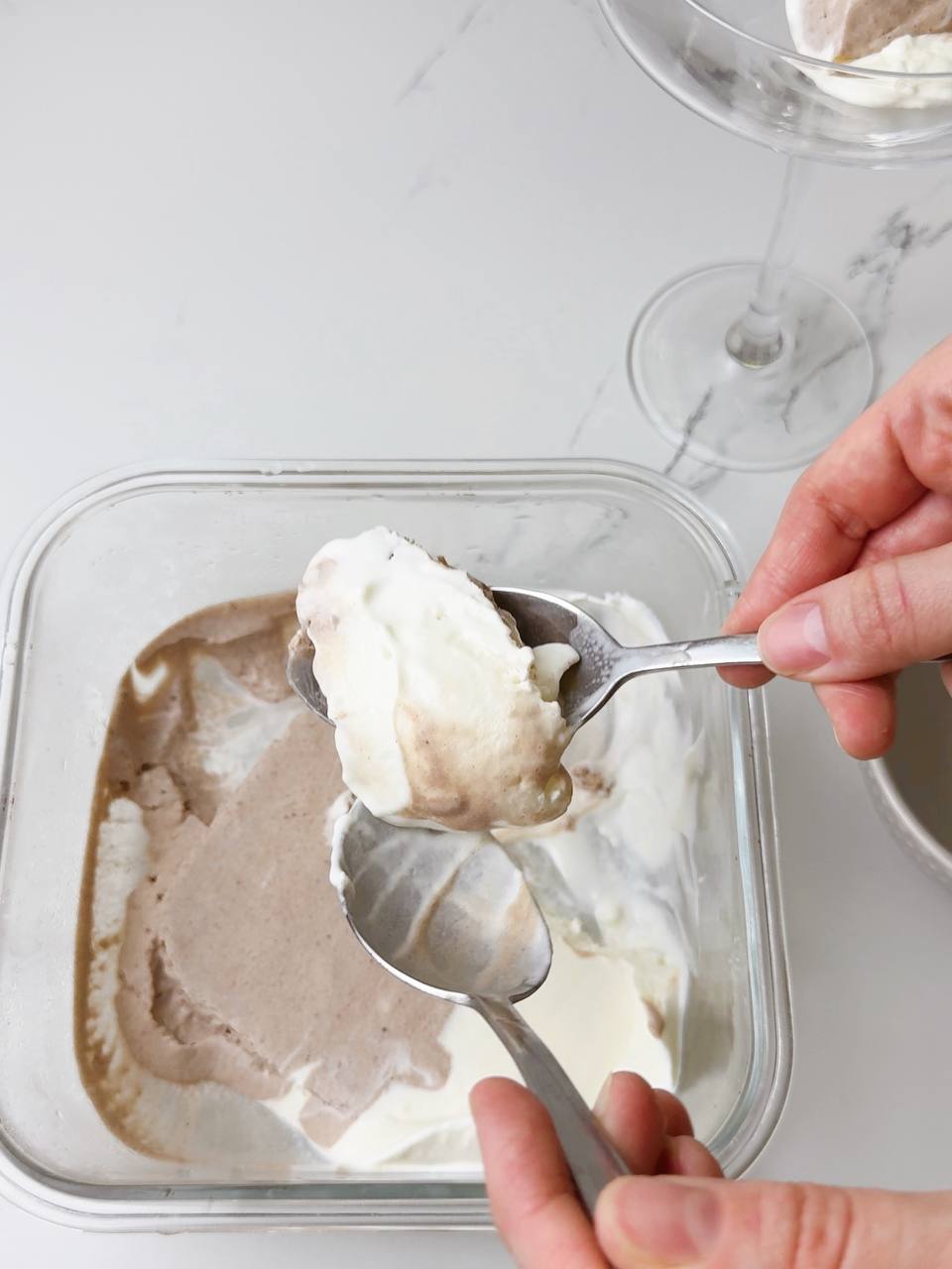 Scooping homemade 3-ingredient ice cream with two tablespoons.