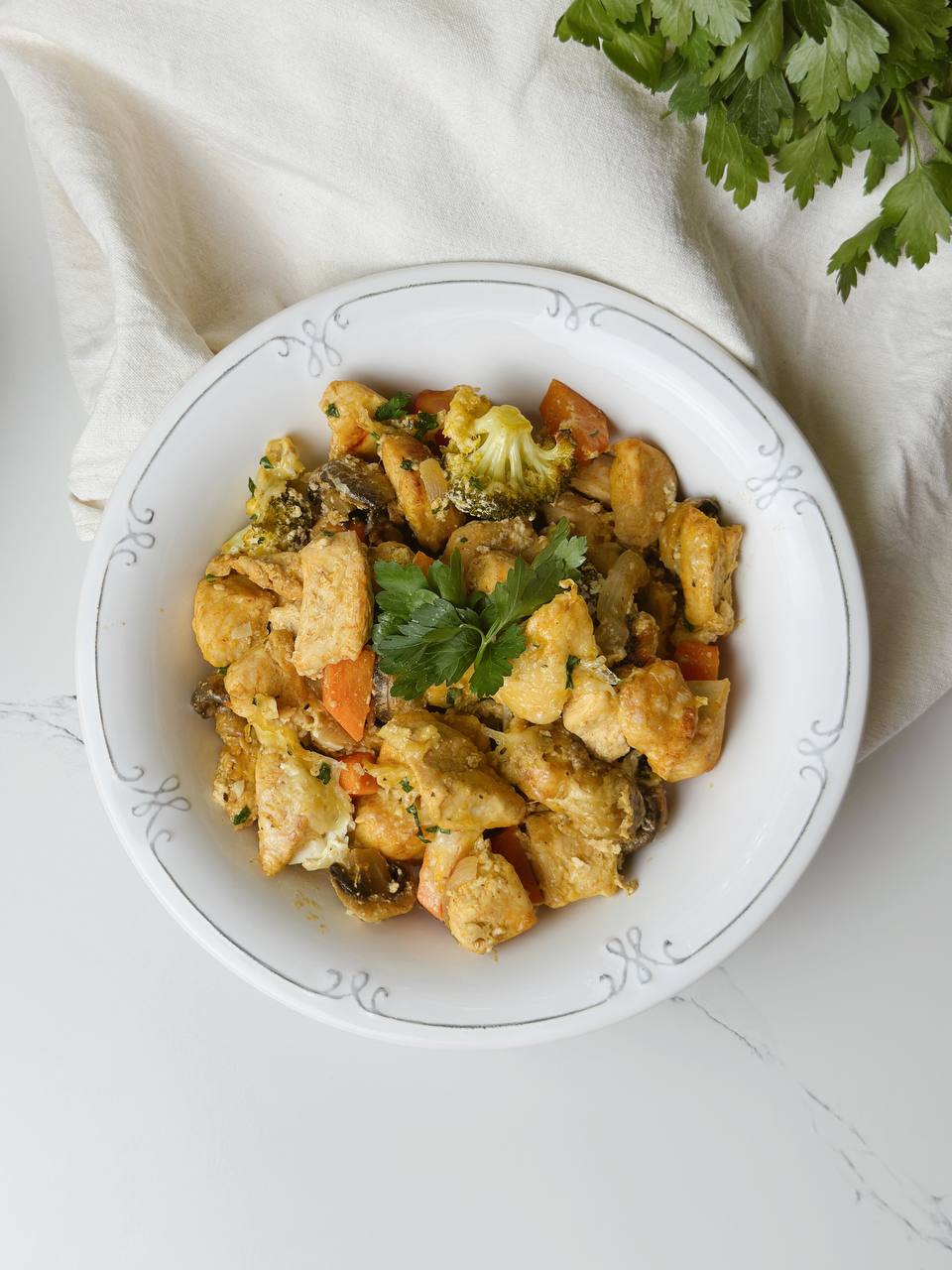 Served portion of Greek Yogurt Chicken and Veggies with parsley garnish