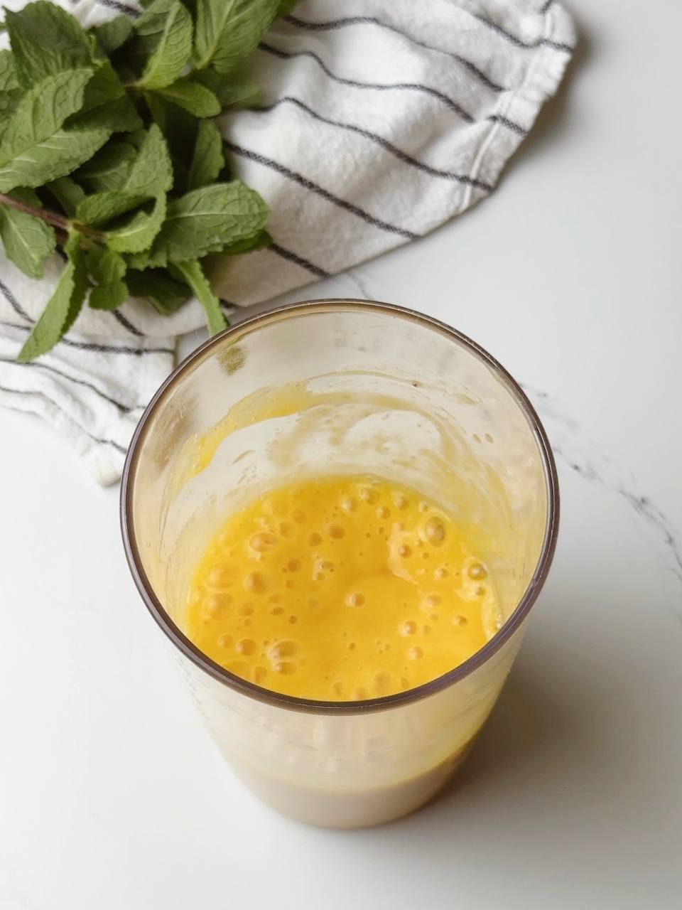 Mango Banana Ginger Smoothie fully blended in blender cup