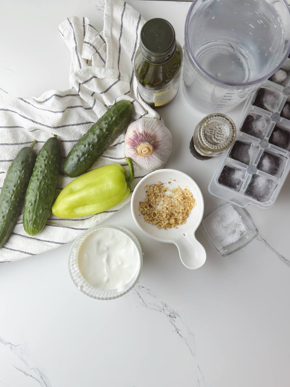 Ingredients for Tarator cold yogurt cucumber soup laid out on a table
