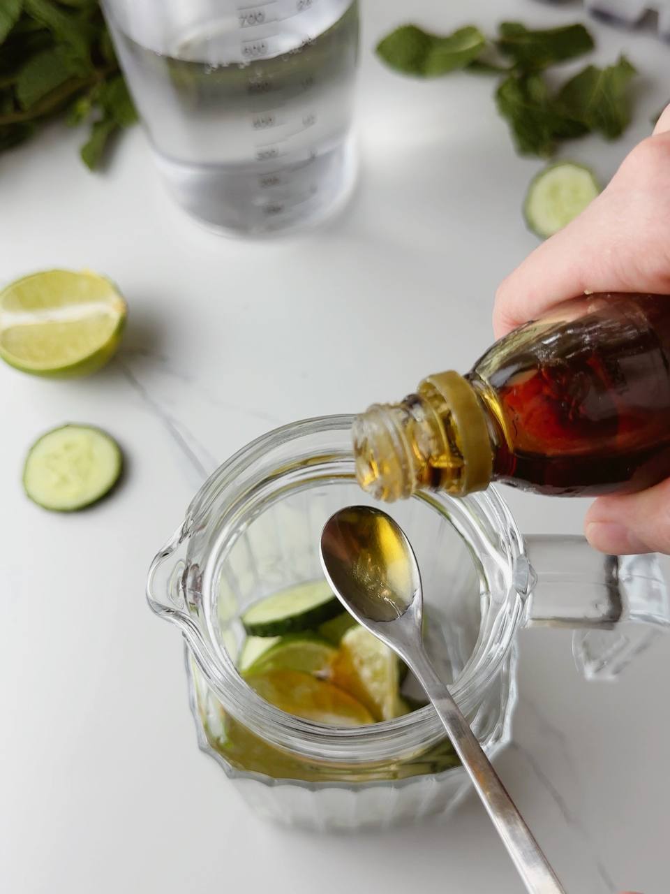 Pouring maple syrup into the pitcher for a hint of sweetness