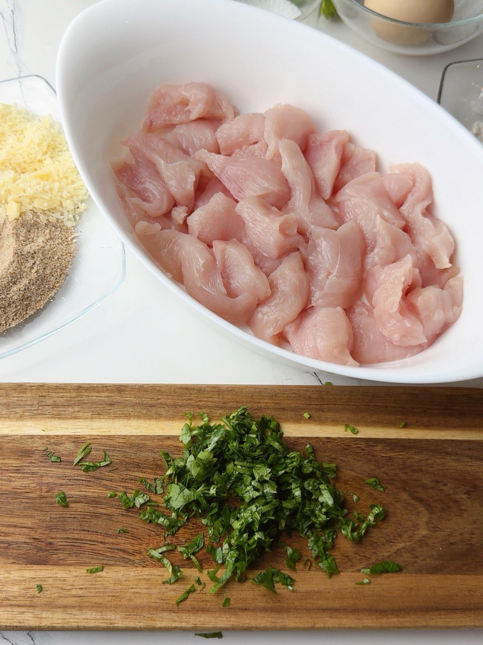 Chopped parsley and diced chicken fillet for nuggets