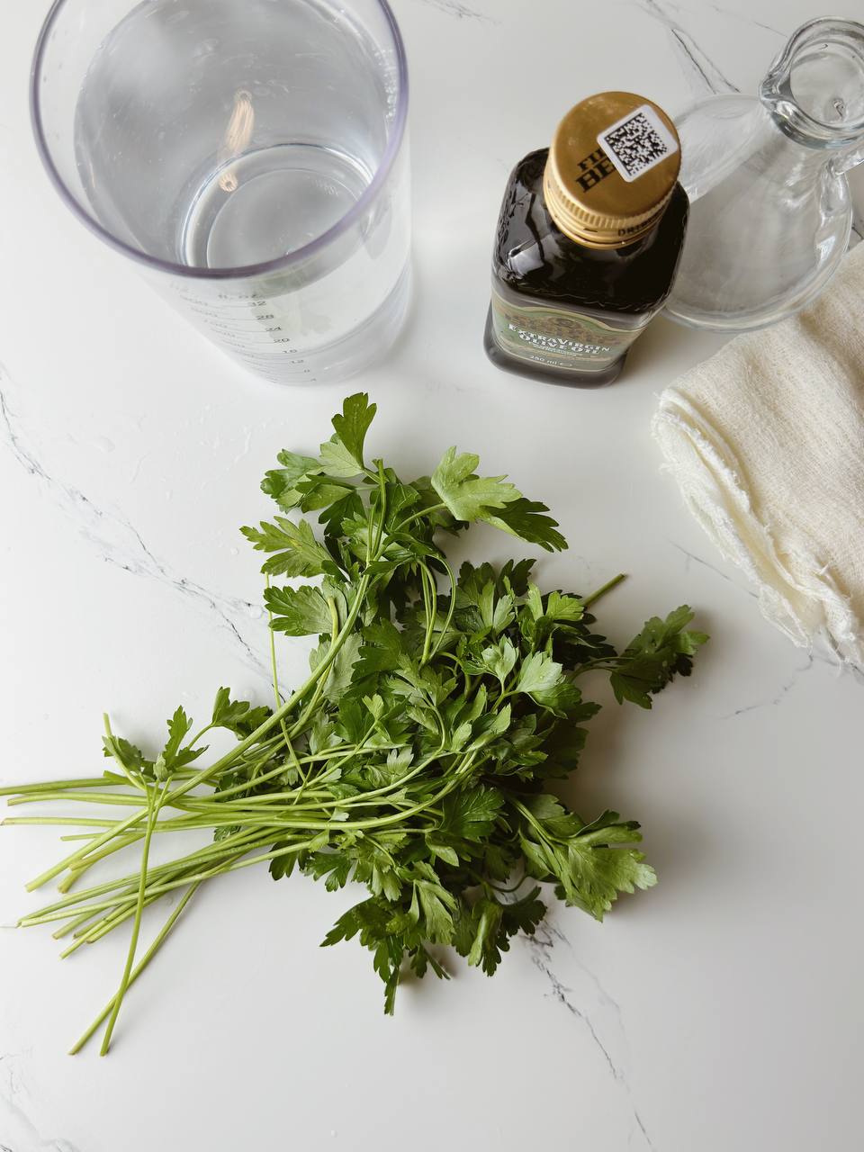 Ingredients for green herb oil: fresh parsley, olive oil, and water