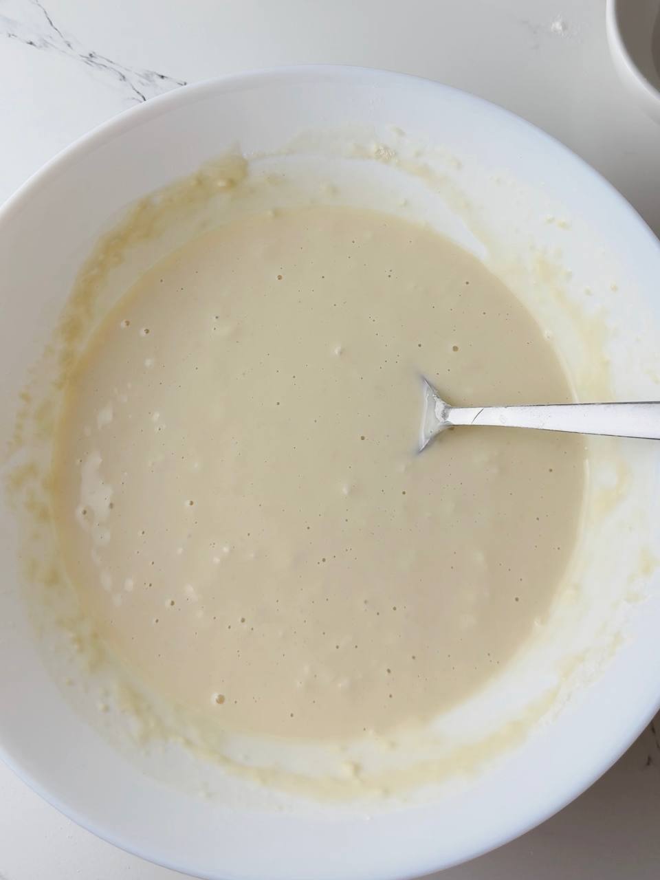 Smooth banana pancake batter ready to be poured onto the tray