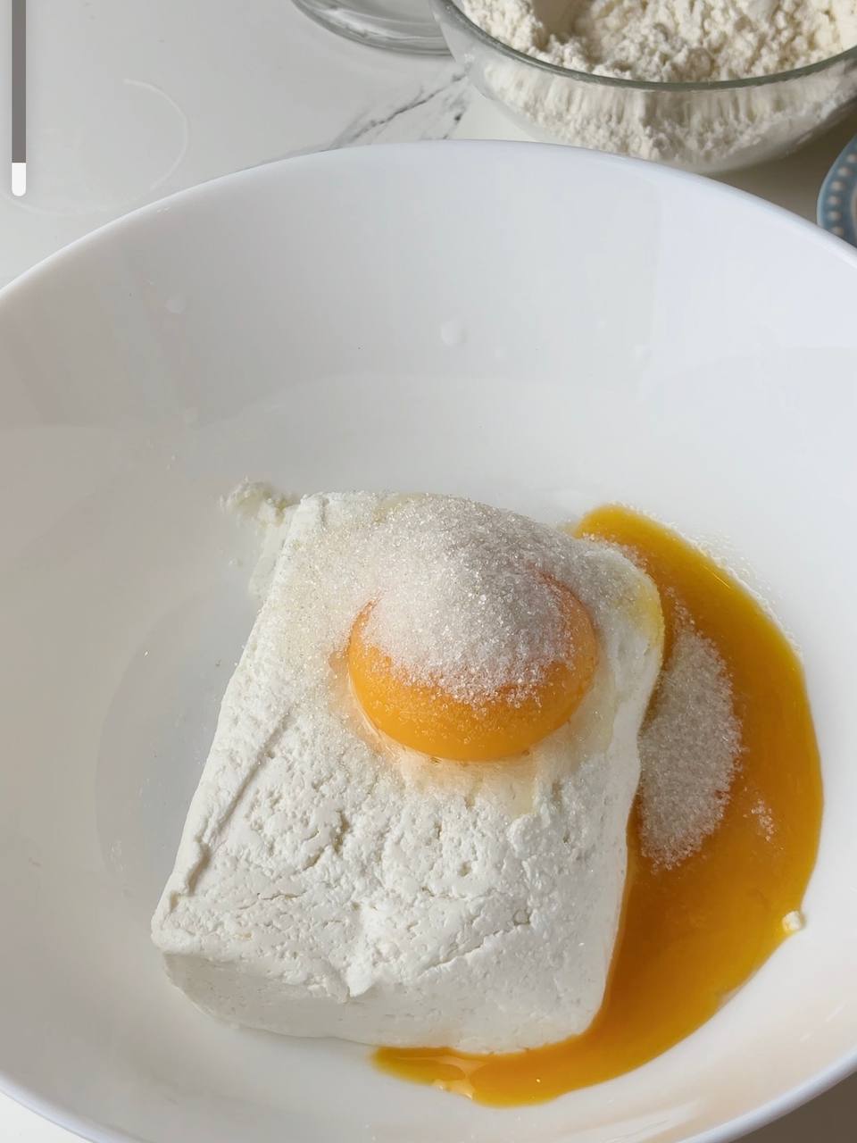 Cottage cheese in a brick mixed with egg yolk and sugar