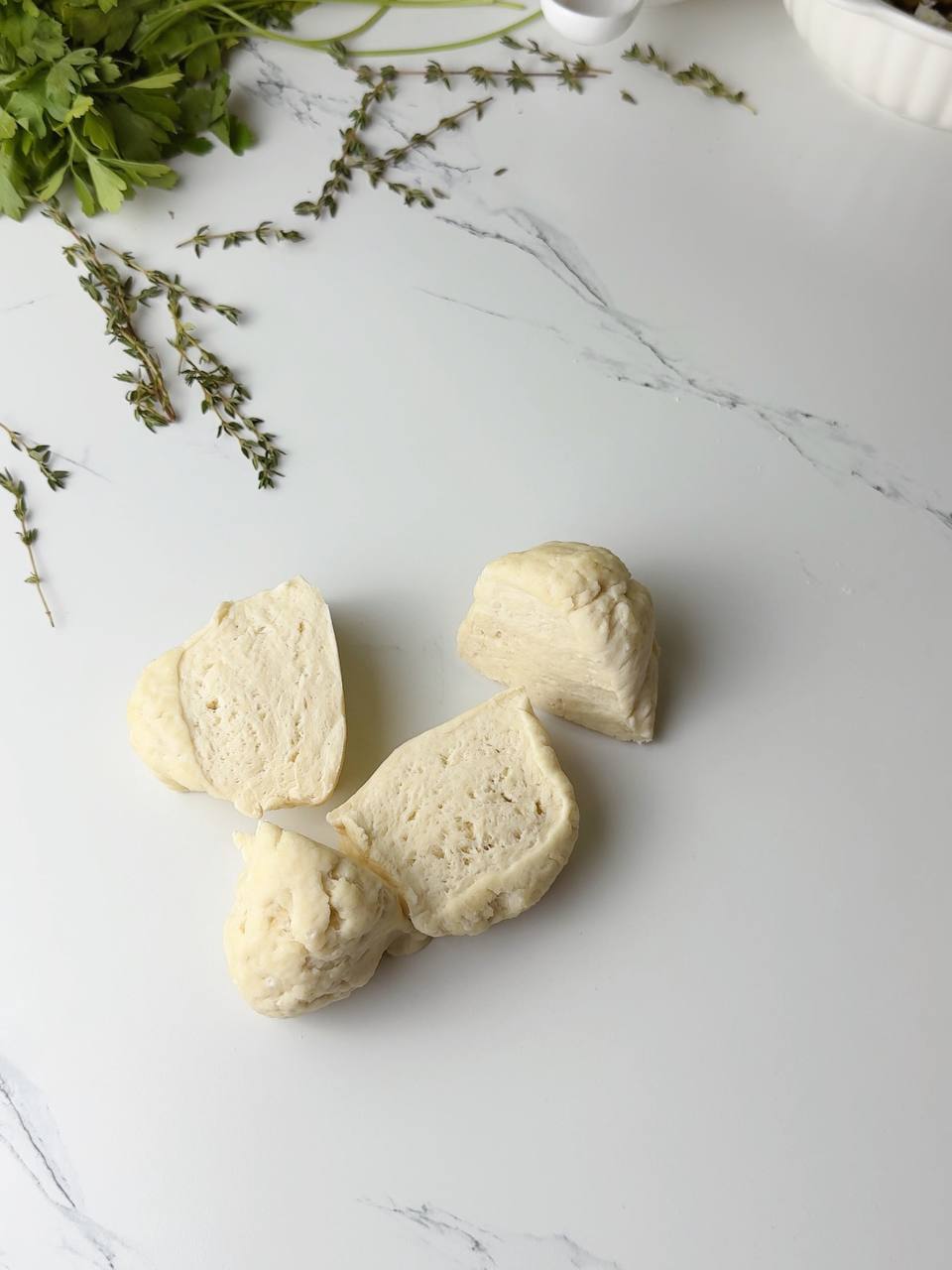 Flatbread dough divided into four equal portions, ready to roll.