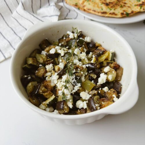 One-tray Mediterranean roasted vegetables with feta, served with garlic flatbread.