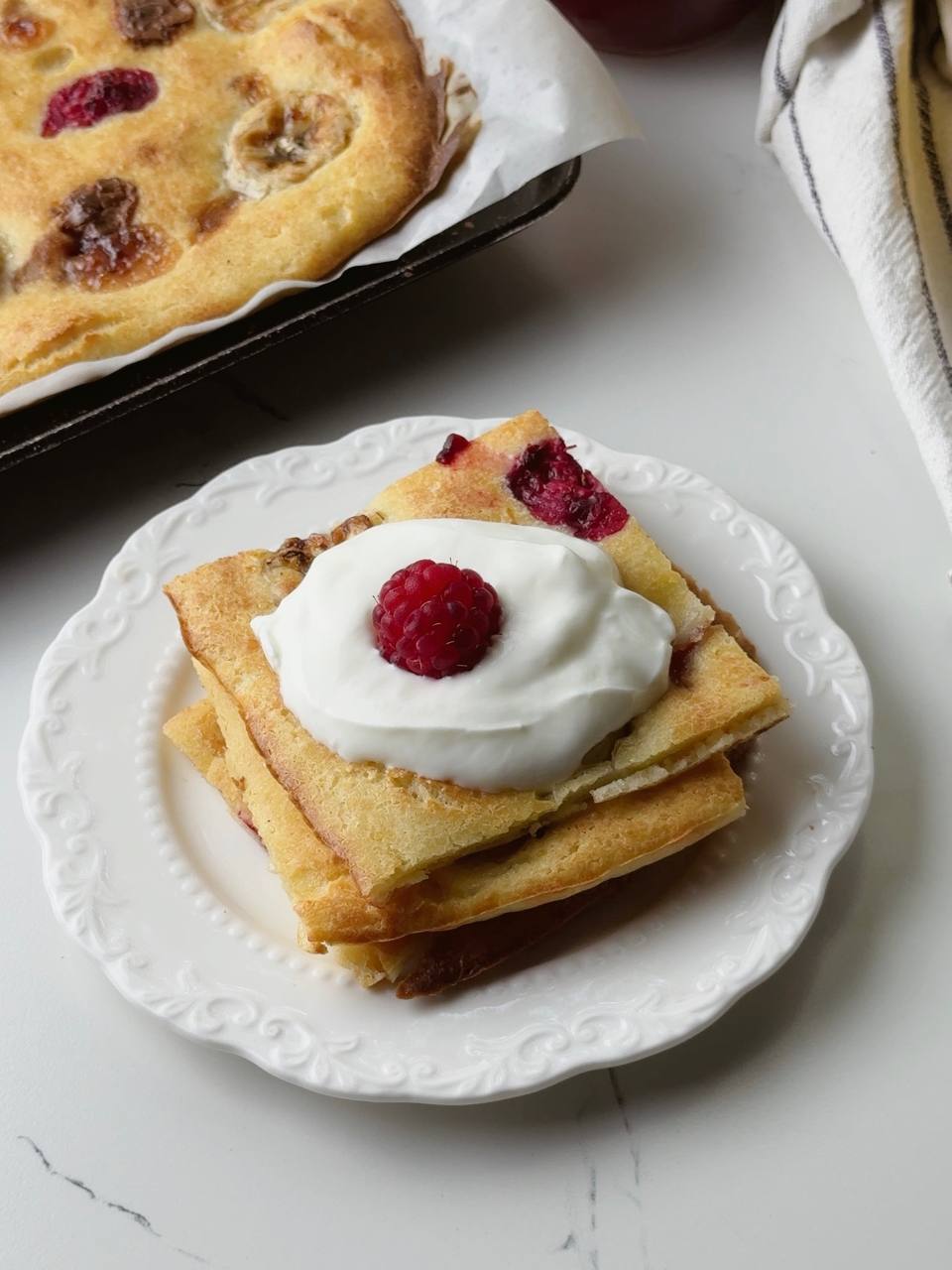 Baked banana pancake served with Greek yogurt and berries