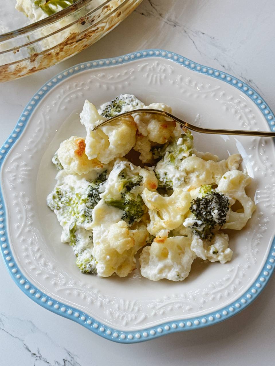 A warm serving of broccoli and cauliflower gratin in the plate