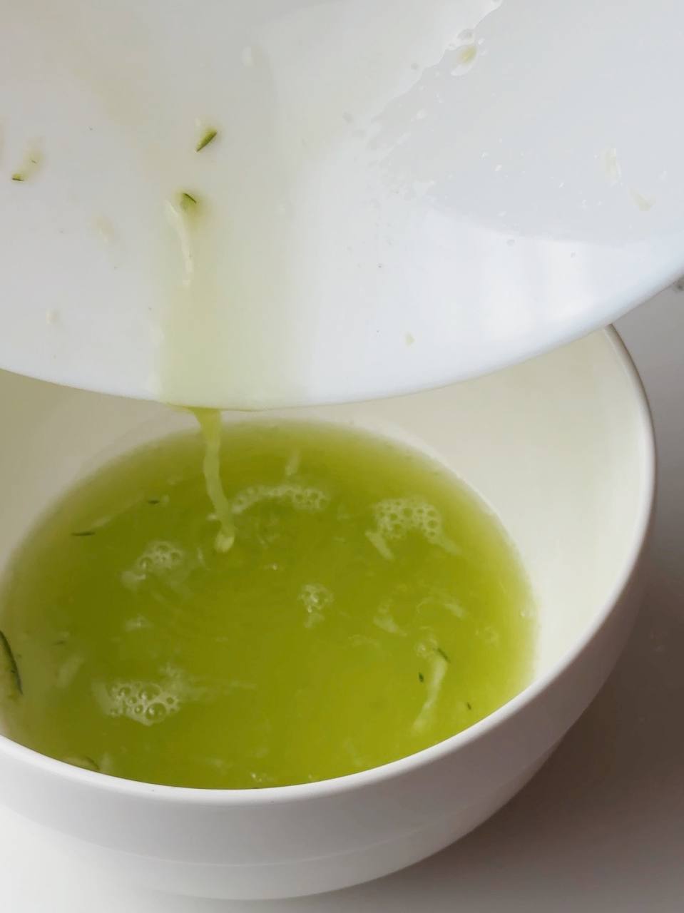 squeezing out liquid from salted zucchini after resting for 20 minutes