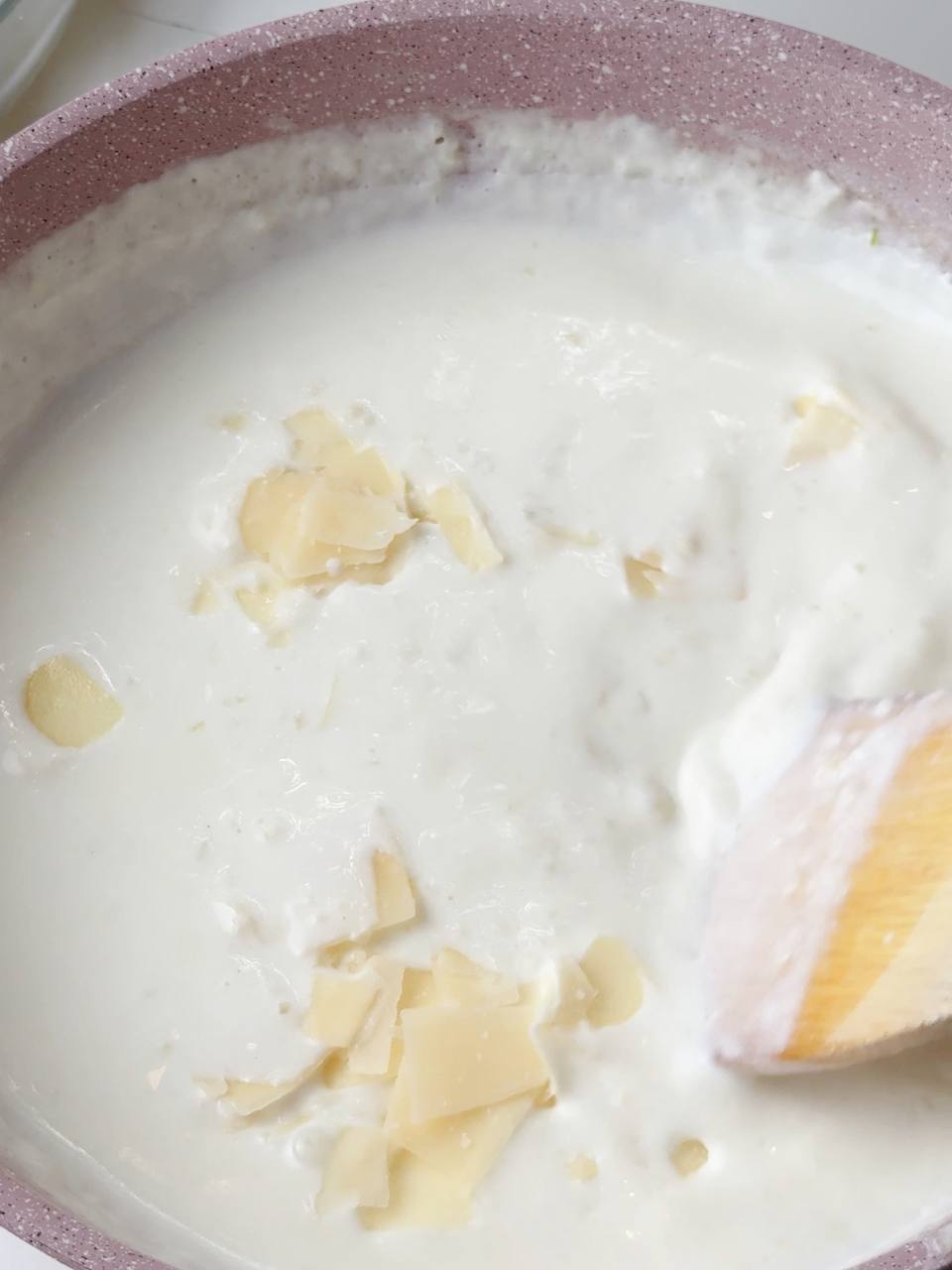 Grated cheese stirred into hot cream sauce for rich flavor.