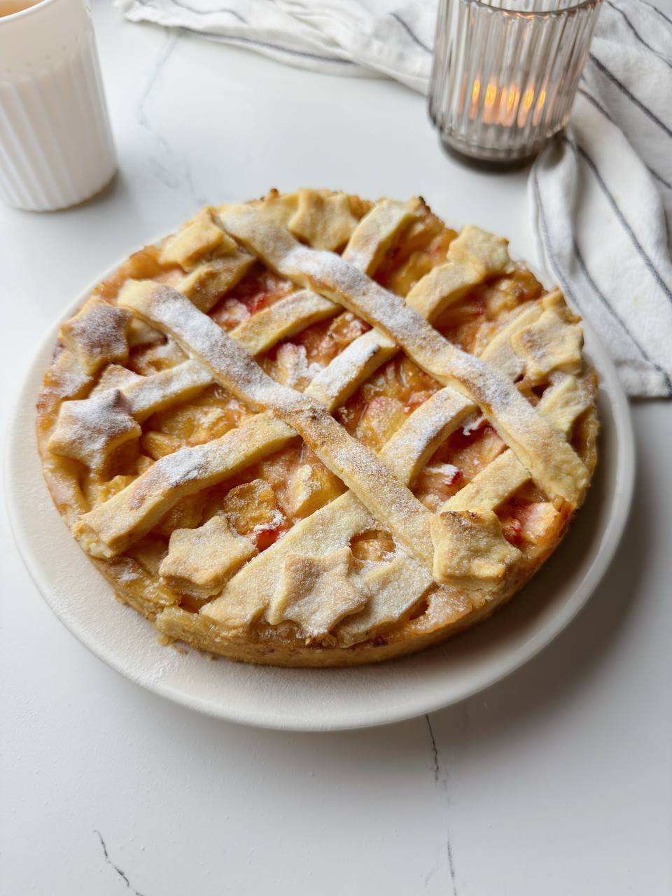 Finished peach pie with mascarpone, golden and ready to serve
