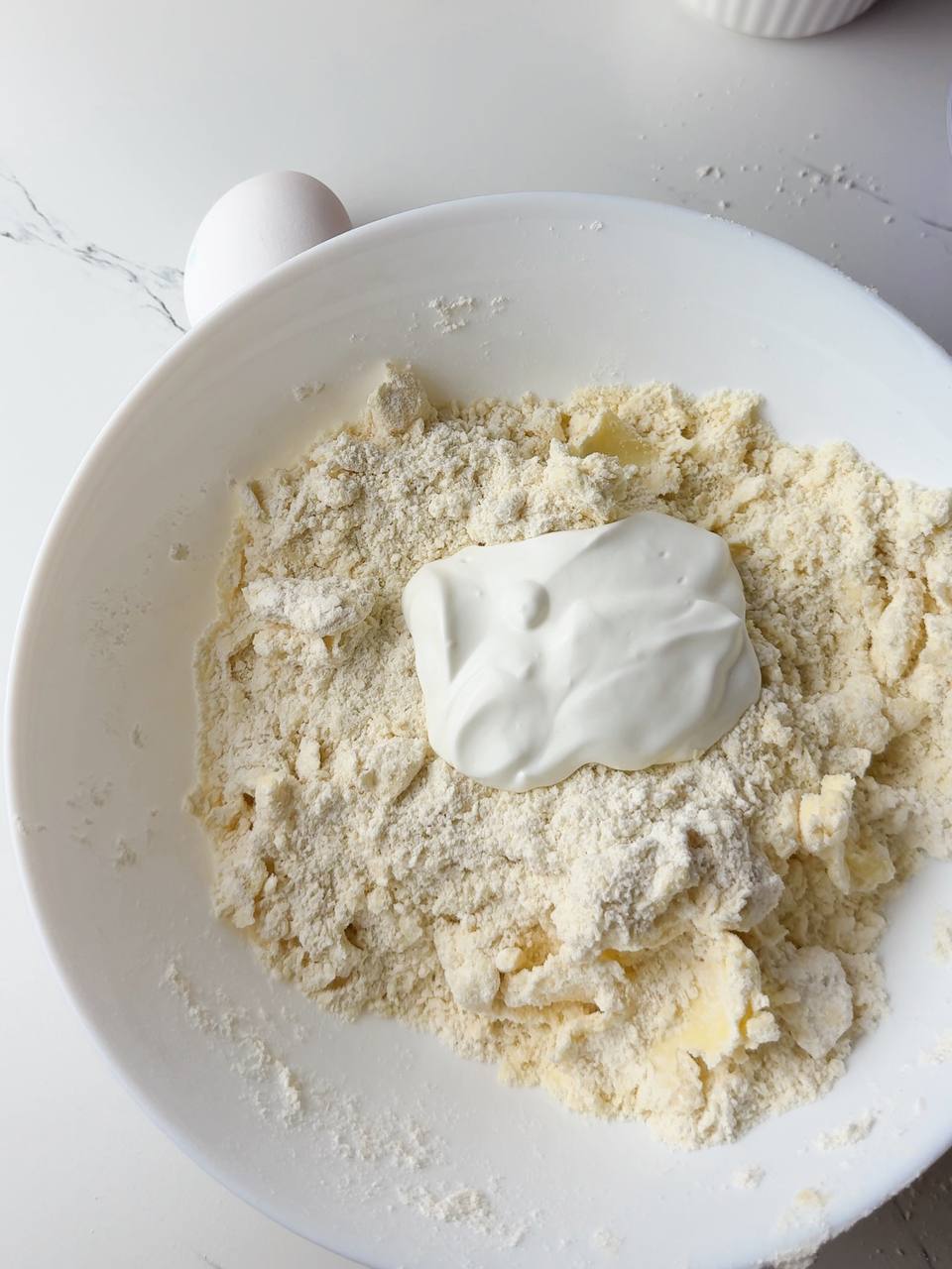 Cold butter mixed with flour and sour cream for the pie dough