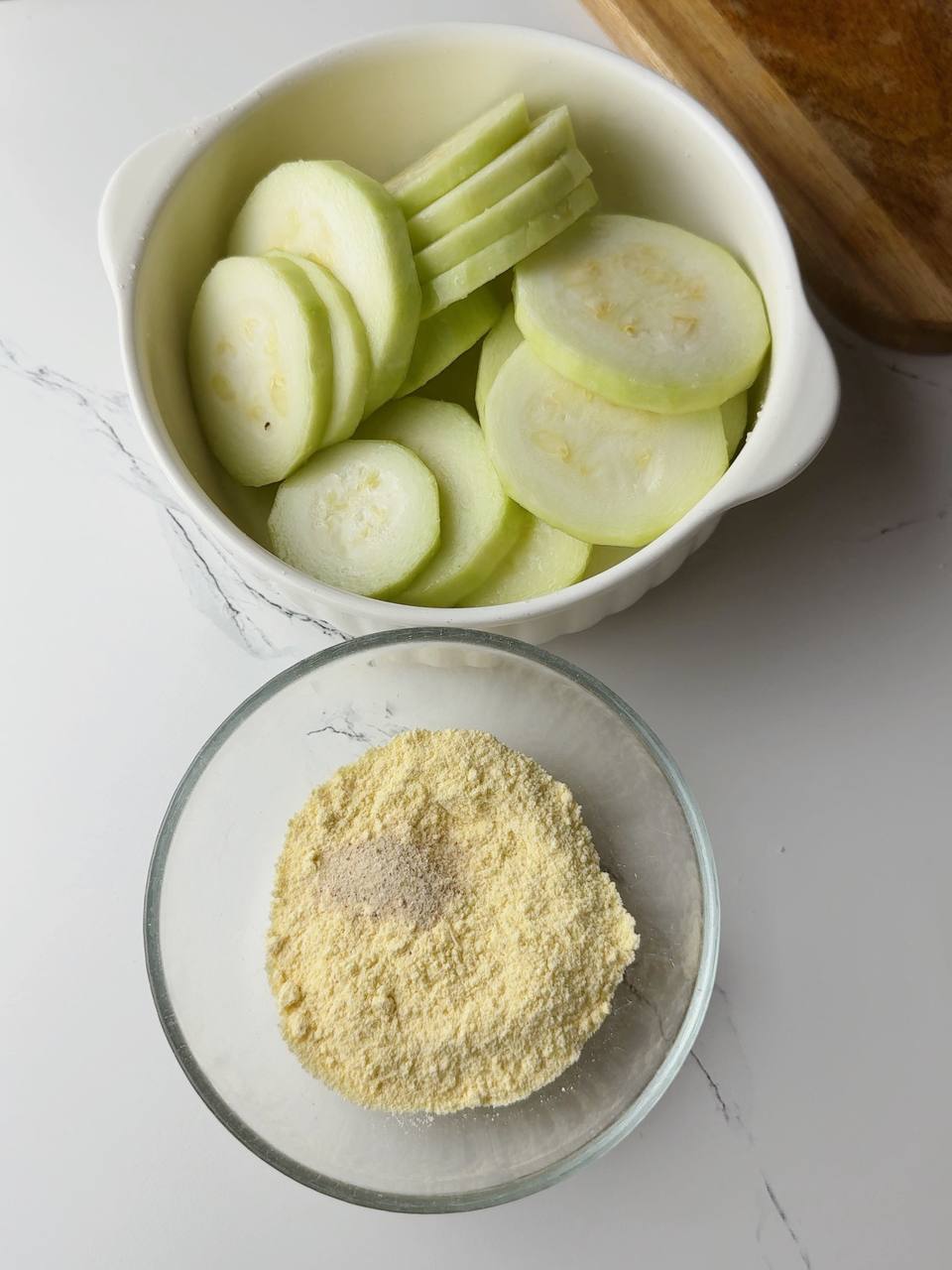 Mixing corn flour with seasonings to coat the zucchini.