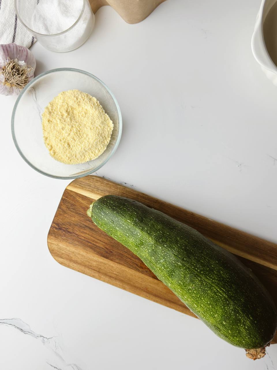 Ingredients for crispy zucchini rounds with corn flour – zucchini, corn flour, salt, and oil.