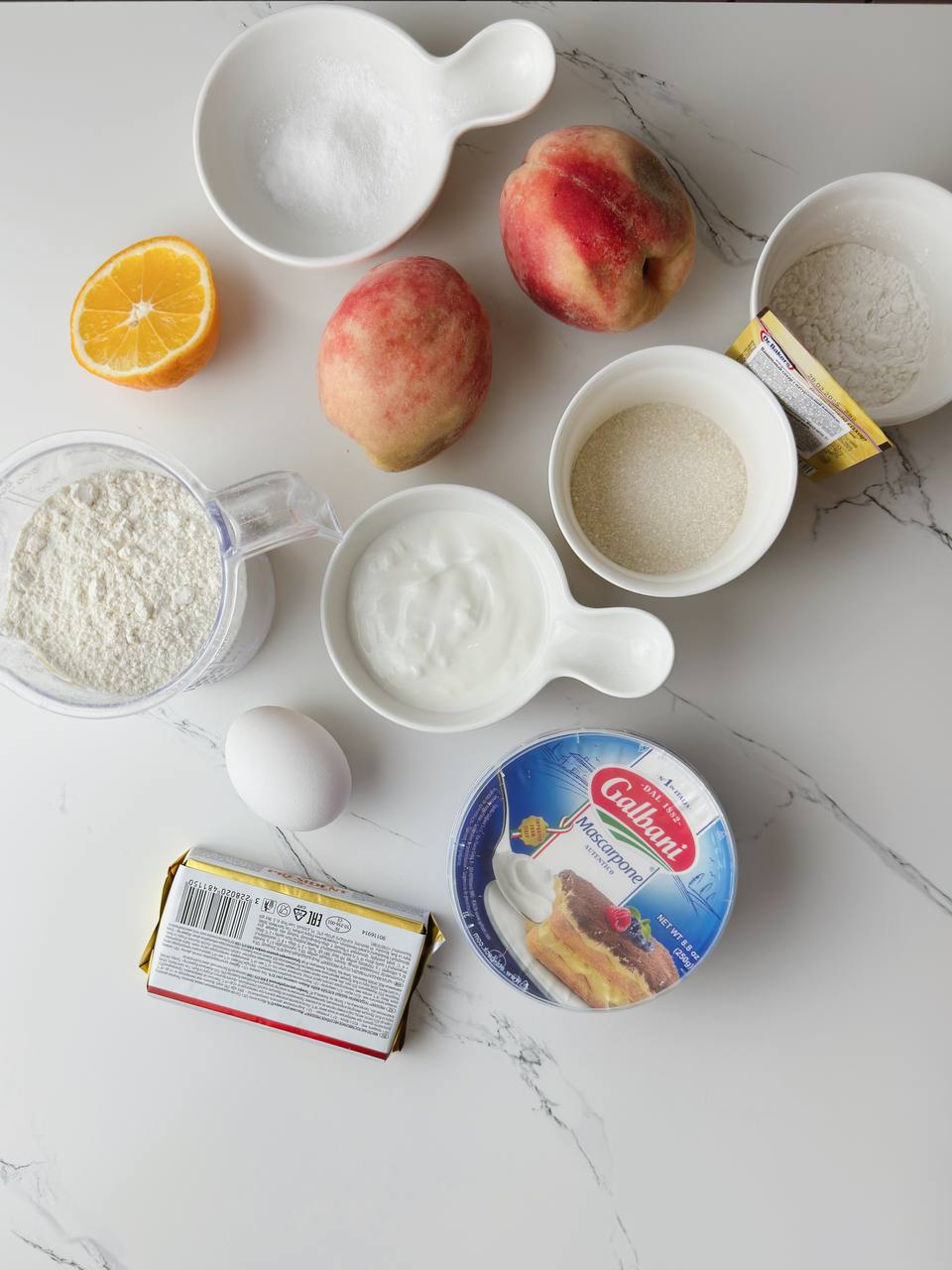 Ingredients for peach pie with mascarpone laid out on the table