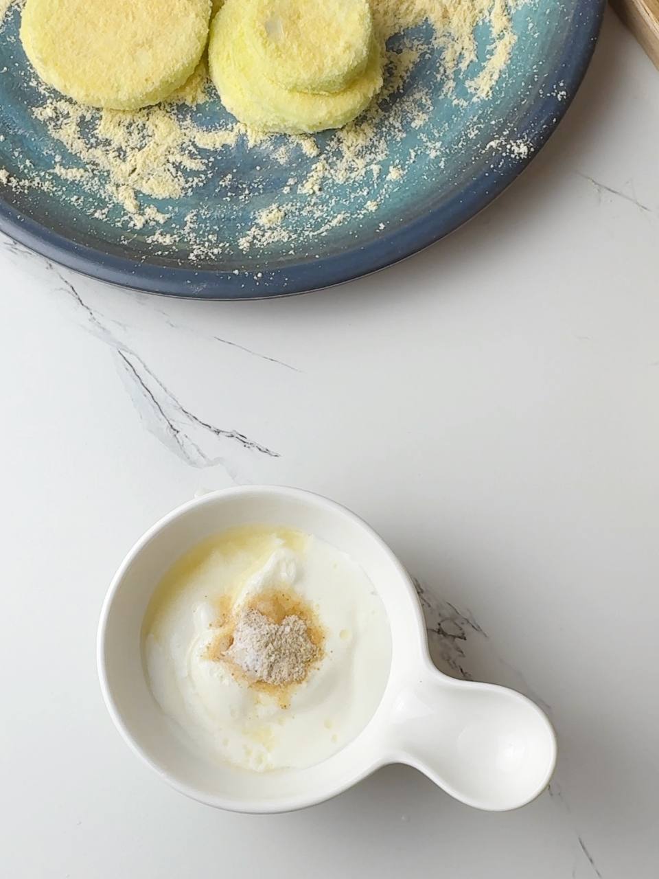 Quick yogurt dip being prepared to serve with crispy zucchini.