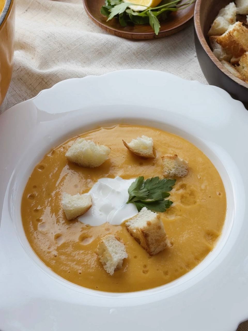 Creamy red lentil soup topped with golden croutons - cozy and comforting autumn dish.